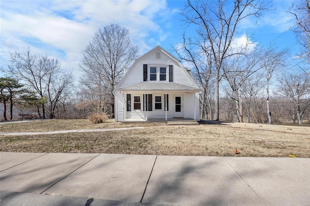 dutch colonial with a shingled roof, a front lawn, a porch, and a gambrel roof