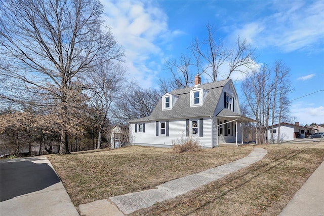 dutch colonial featuring covered porch, a gambrel roof, a front lawn, and roof with shingles