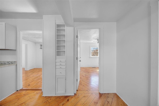 corridor with light wood-style flooring