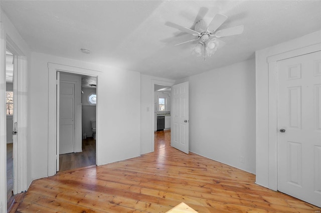 empty room featuring a ceiling fan and light wood-type flooring