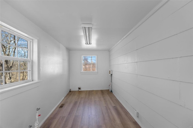 empty room featuring visible vents and wood finished floors