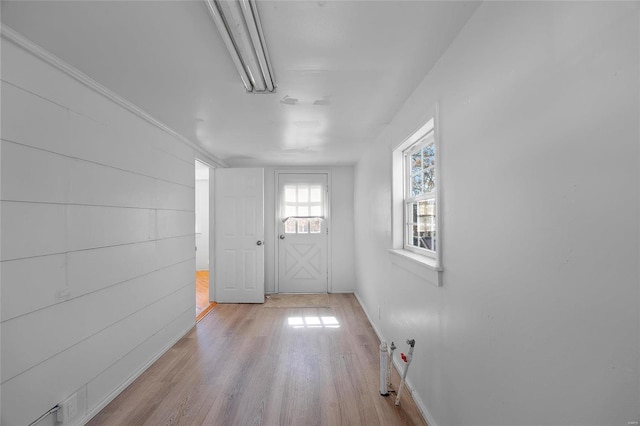 doorway to outside with baseboards and wood finished floors