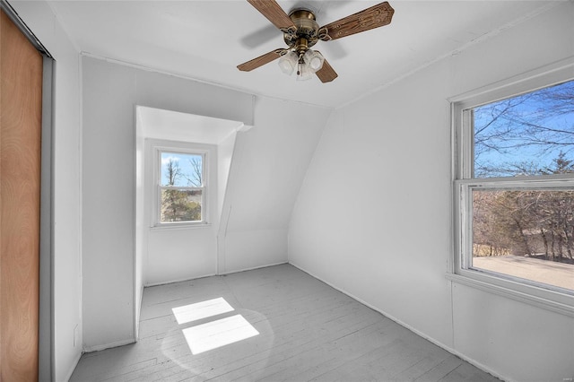 unfurnished room featuring lofted ceiling and a ceiling fan