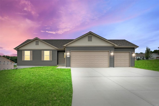 ranch-style house featuring an attached garage, concrete driveway, a shingled roof, and a front yard