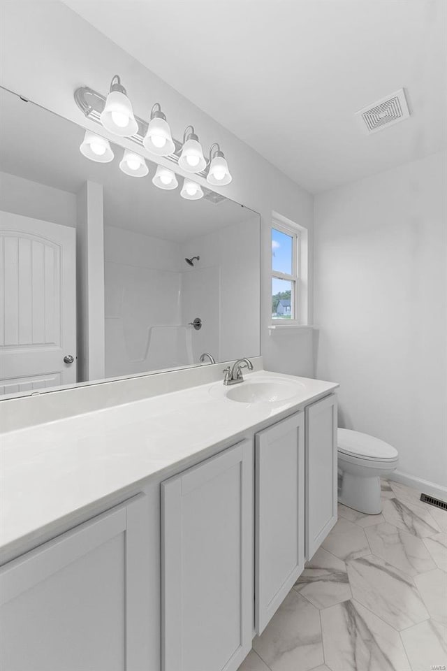 bathroom with toilet, marble finish floor, vanity, and visible vents