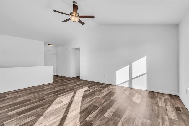 interior space with a ceiling fan, visible vents, vaulted ceiling, and wood finished floors