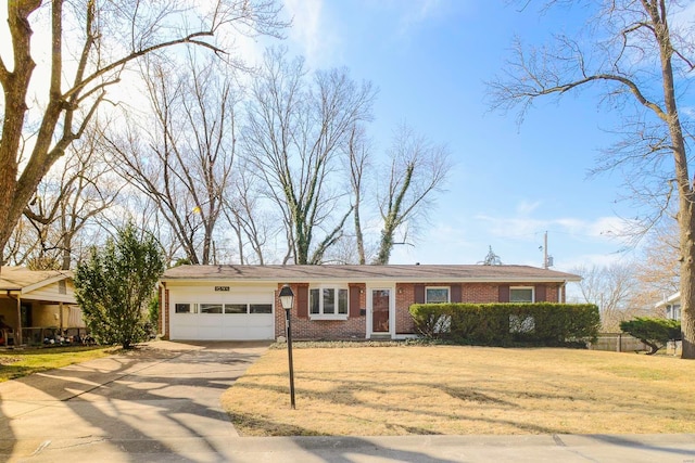 view of front of house featuring a garage, a front lawn, brick siding, and driveway