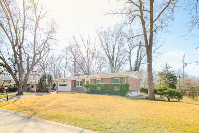 view of front of home with a front yard and brick siding