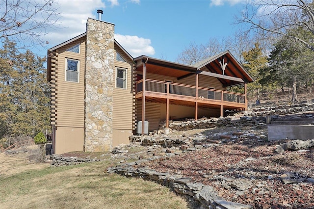 view of home's exterior featuring log exterior, a chimney, and a yard