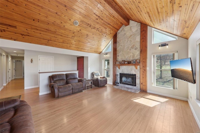 living room with beamed ceiling, a stone fireplace, wooden ceiling, wood finished floors, and high vaulted ceiling