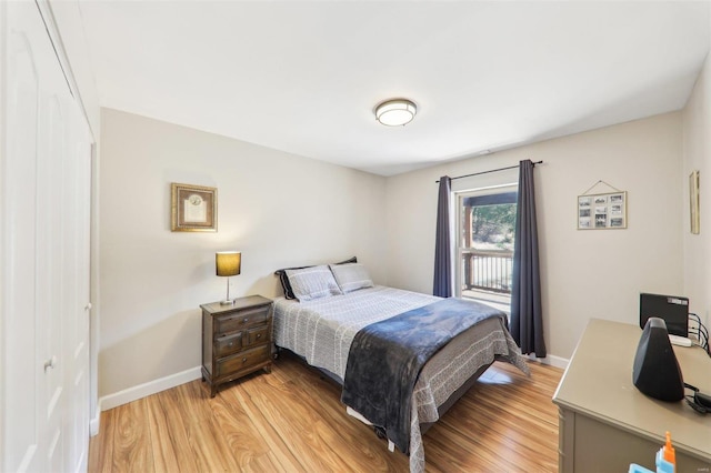 bedroom featuring baseboards and light wood-style floors