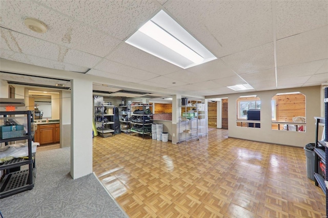 basement featuring a paneled ceiling