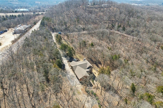 bird's eye view with a wooded view