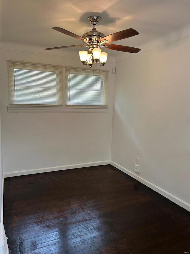 spare room featuring ceiling fan, baseboards, and wood finished floors