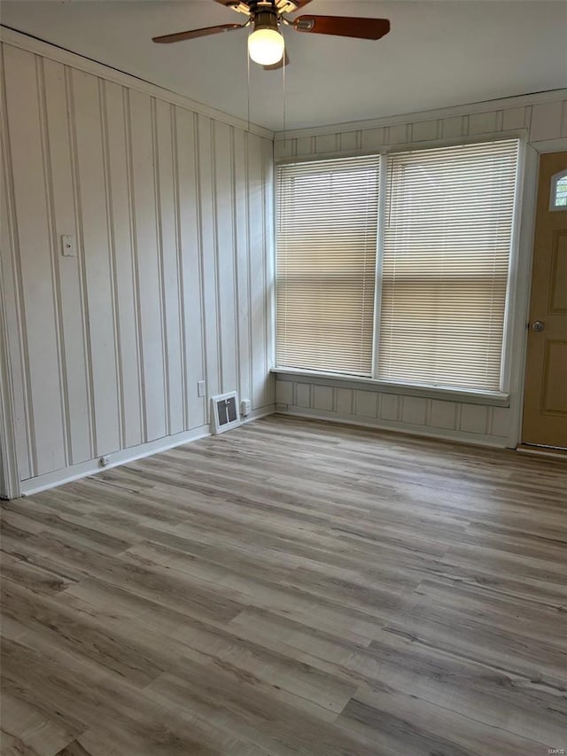 spare room with visible vents and wood finished floors