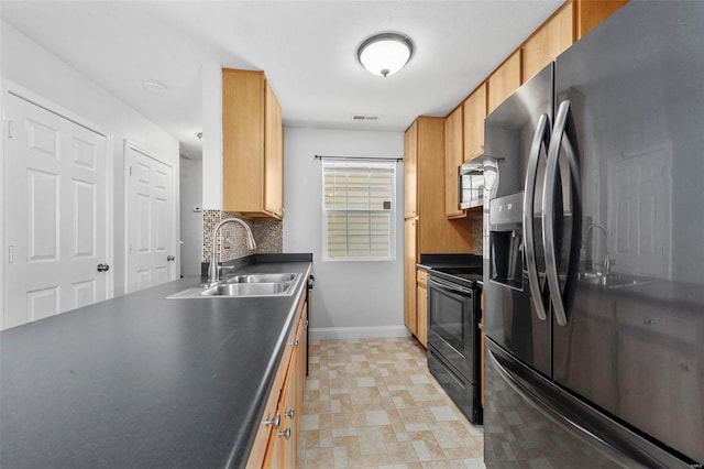 kitchen with a sink, visible vents, dark countertops, and black appliances