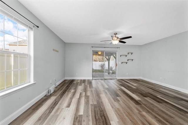 unfurnished room featuring ceiling fan, baseboards, and wood finished floors