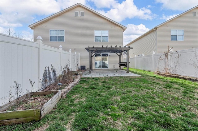 rear view of house featuring a vegetable garden, a yard, a fenced backyard, a pergola, and a patio area