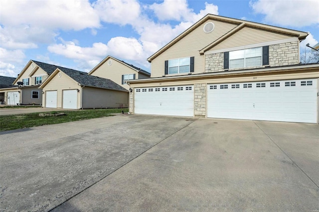 view of front of home with stone siding and driveway