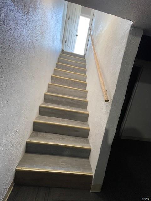 stairs with a textured wall