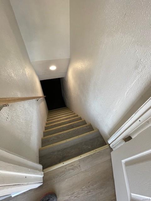 stairway with a textured wall