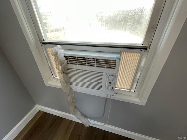 interior details featuring baseboards and wood finished floors