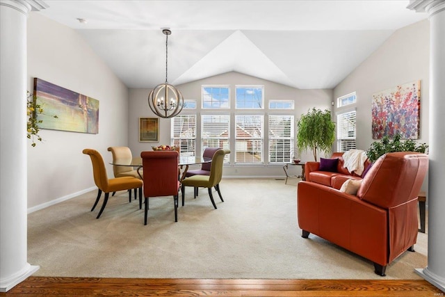 dining room featuring light colored carpet, decorative columns, and a notable chandelier