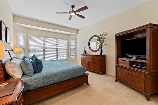 bedroom featuring ceiling fan, baseboards, and light colored carpet