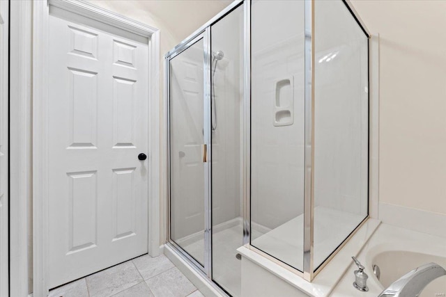 full bath with a garden tub, a shower stall, and tile patterned floors