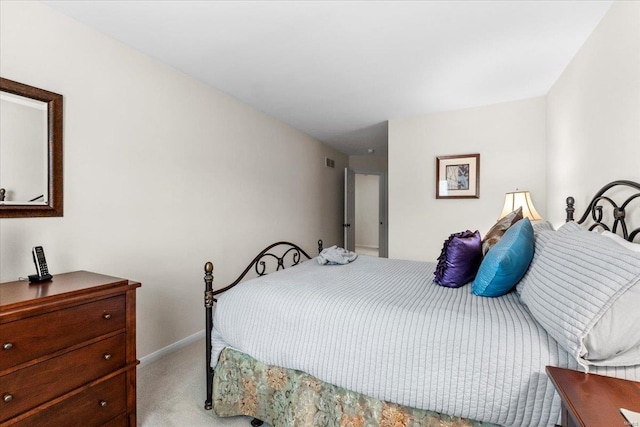 carpeted bedroom with visible vents and baseboards