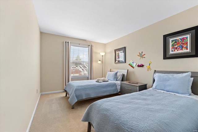 bedroom featuring baseboards and light colored carpet