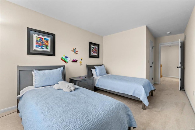 bedroom with baseboards and light colored carpet