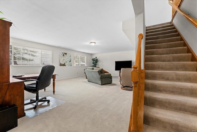 carpeted office featuring baseboards