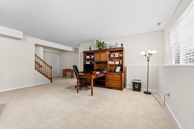 office area with light carpet, visible vents, and baseboards