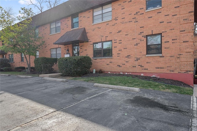 view of property featuring uncovered parking