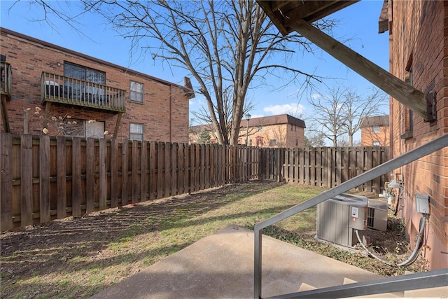 view of yard with a patio area, cooling unit, and a fenced backyard