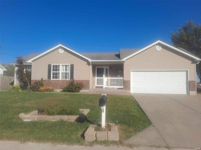 single story home with a garage, a front yard, concrete driveway, and brick siding