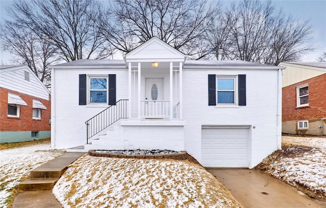 view of front facade featuring concrete driveway, brick siding, and an attached garage