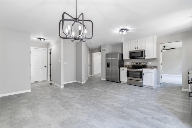 kitchen with appliances with stainless steel finishes, white cabinetry, and baseboards