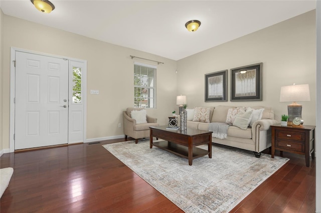 living room featuring baseboards, dark wood finished floors, and visible vents