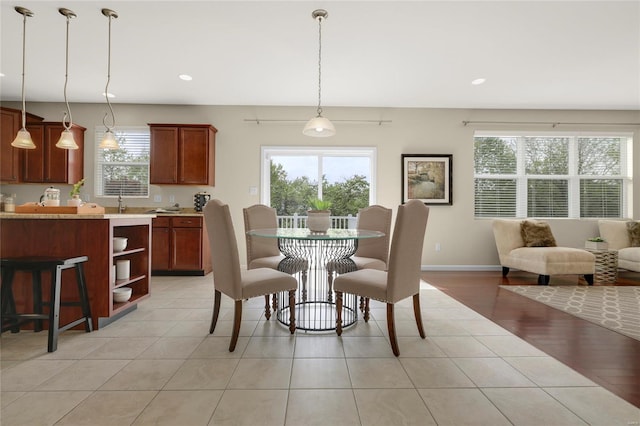 dining room featuring recessed lighting, baseboards, and light tile patterned flooring