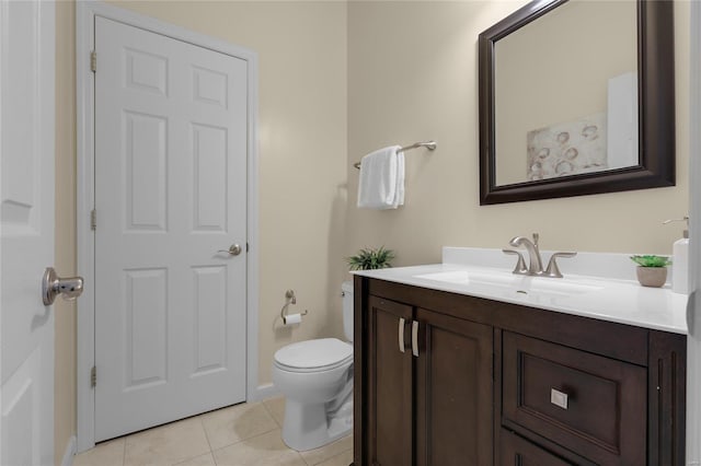 bathroom featuring vanity, baseboards, tile patterned floors, and toilet
