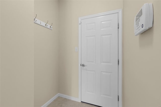 doorway to outside with baseboards and light tile patterned floors