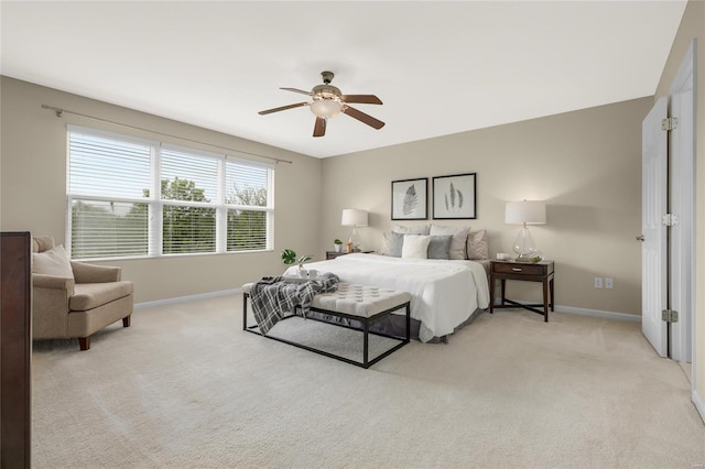 bedroom featuring baseboards, ceiling fan, and light colored carpet