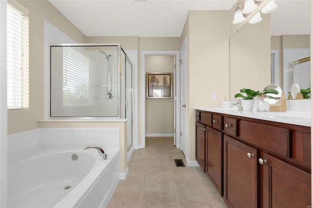 bathroom with tile patterned flooring, double vanity, a shower stall, visible vents, and a garden tub