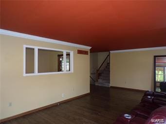 unfurnished living room with stairs, baseboards, and wood finished floors