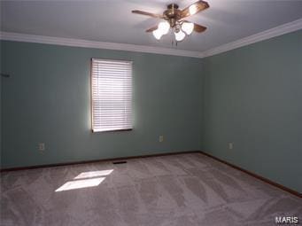 carpeted empty room featuring crown molding, baseboards, and ceiling fan