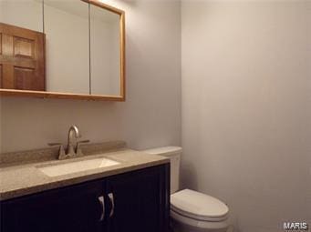 bathroom with toilet and vanity