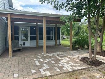 view of patio with a carport and a sunroom