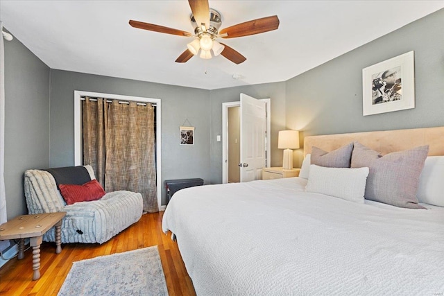 bedroom featuring wood finished floors and a ceiling fan